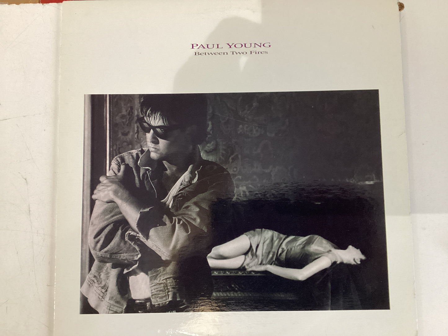 YOUNG, PAUL = BETWEEN TWO FIRES (CDA 1986) (USED)