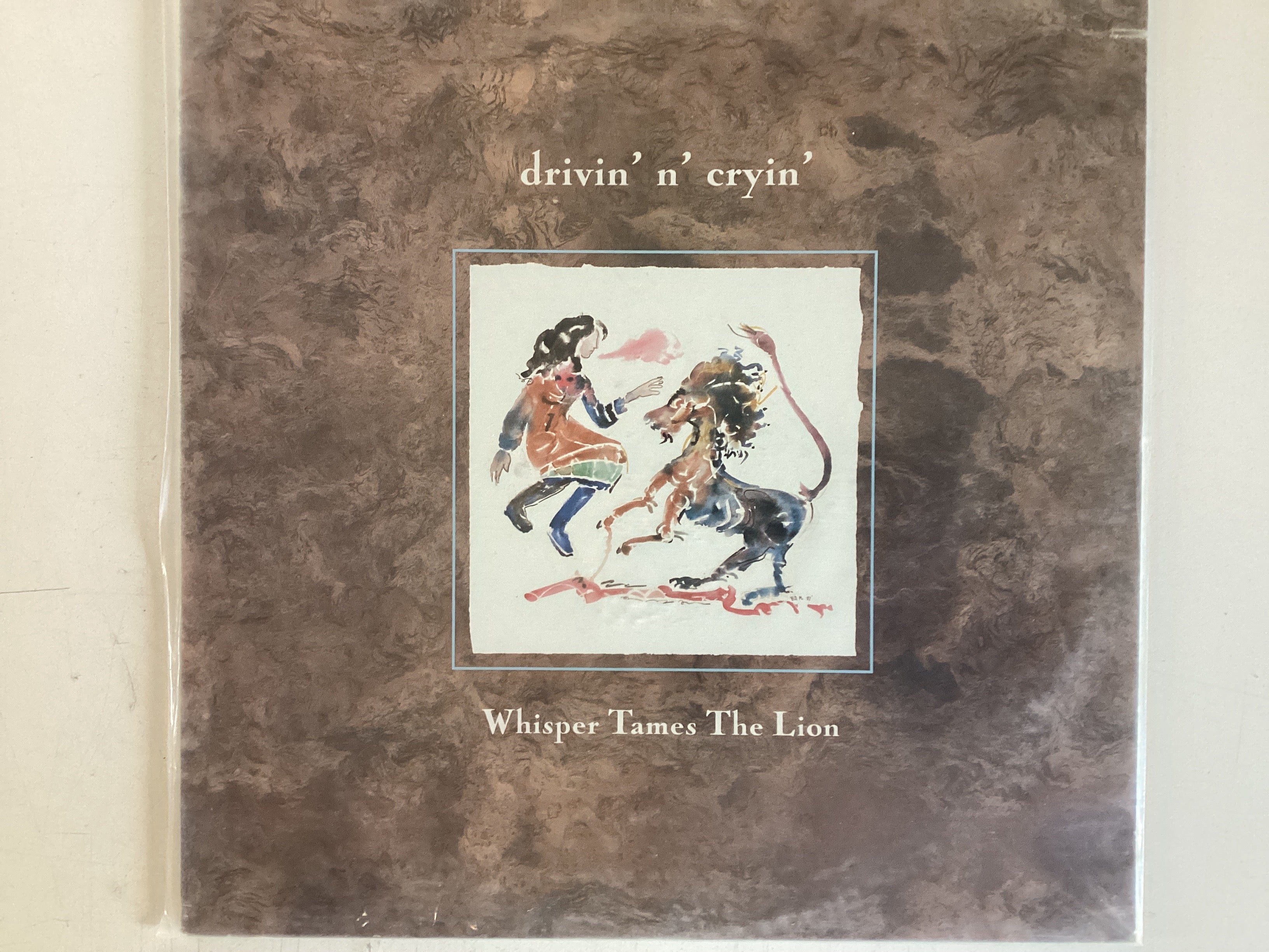 DRIVIN’ N’ CRYIN’ = WHISPER TAMES THE LION (CDA 1988) (USED)